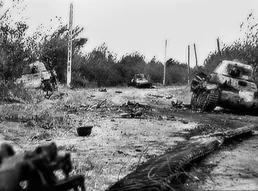 Photo of some tanks on a battlefield with their barrels aiming at the camera