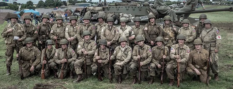 Group of soldiers stood in front of a tank all in Aireborne 505th uniform and rifles